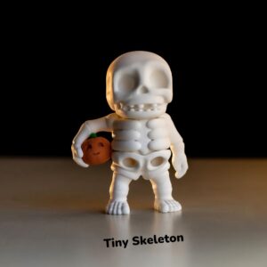 tiny skeleton holding pumpkin